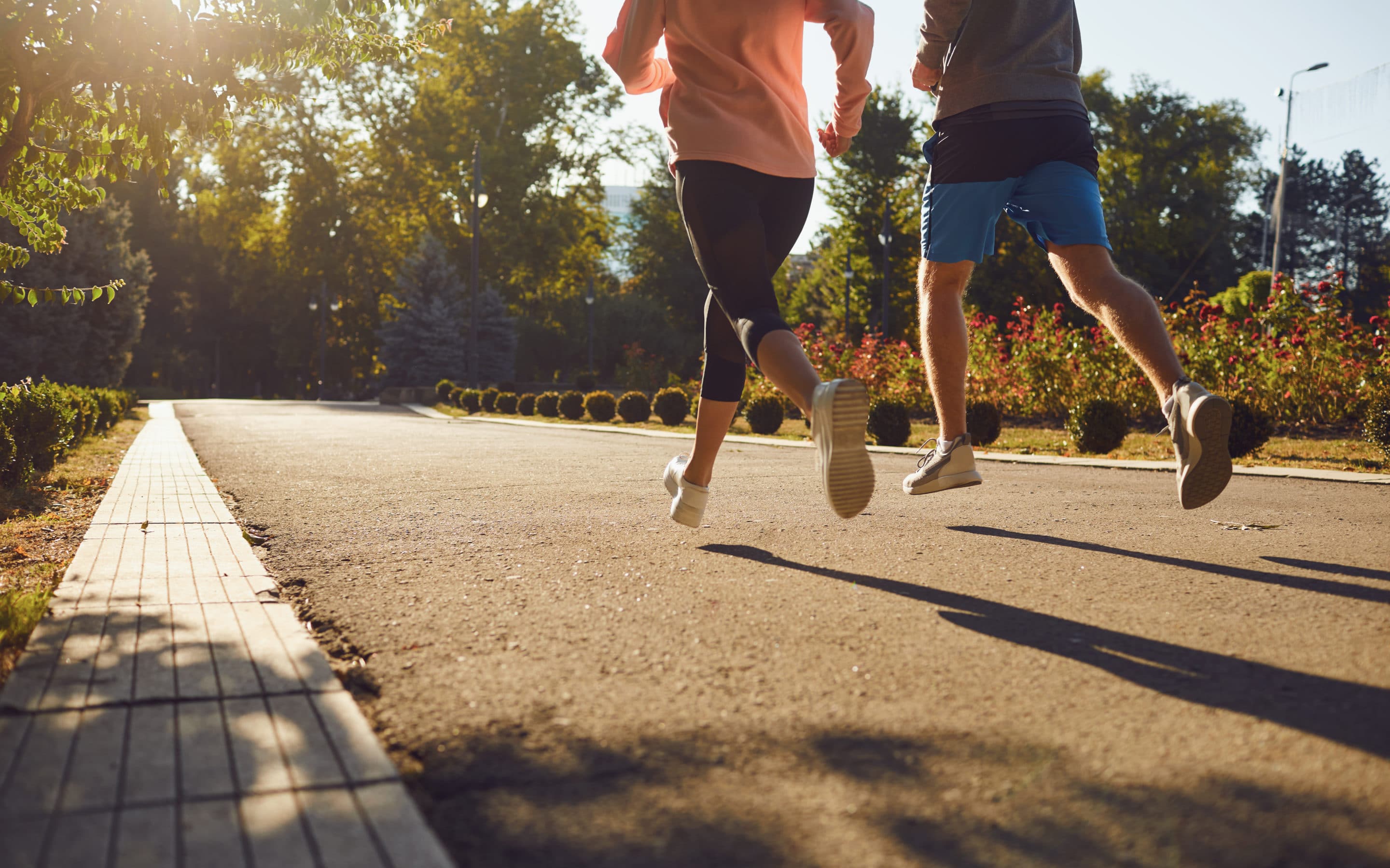 A man and a woman are running along the city street in the morning. A man and a woman are running along the city street in the morning.